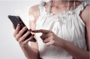 a person holding a smart phone with an email icon on it
