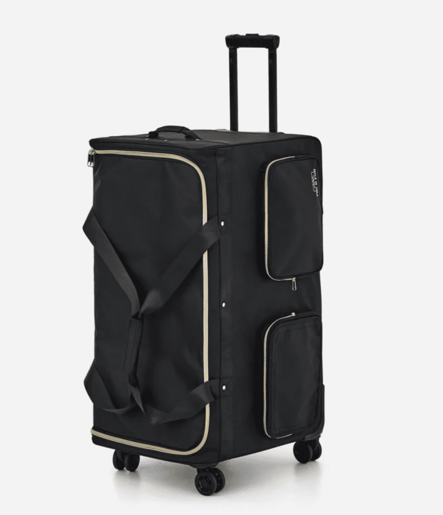 Rac N Roll Built-In Dance Bag in black with gold trim, featuring a retractable handle, four spinner wheels, large zippered main compartment, and two exterior storage pockets.